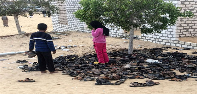 Egyptian_children_stand_near_pile_of_footwear_at_the_Rawda_mosque_near_North_Sinai_provincial_capital_El_Arish_11252017_AFP