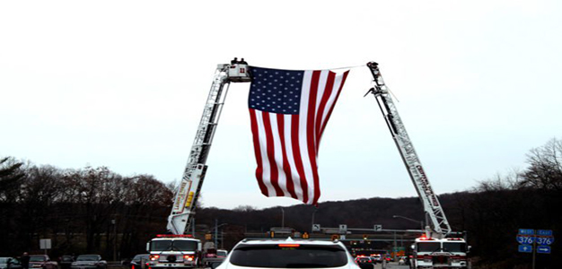 Staff_Sgt_Dylan_Elchin_honor_escort_hanging_American_flag